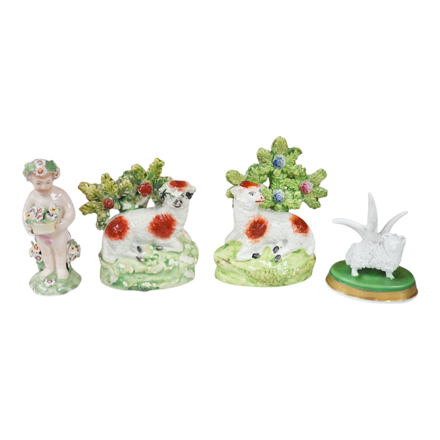 A pair of early 19th century pearlware models of sheep, an English porcelain ‘sheep’ ring tree and a Derby figure of a cherub, tallest 10 cm. Condition - ring tree restored the others fair to good